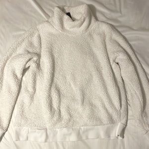 A fluffy sweatshirt. No stains extremely comfy has pockets. turtleneck.